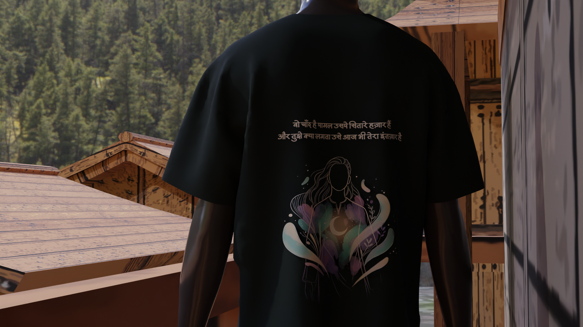Person wearing a black t-shirt with a colorful design on the back, standing in a wooden cabin setting.
